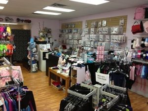 Inside Dance Box in Langley: racks of pink and purple dancewear, a wall of boxed shoes and the front counter