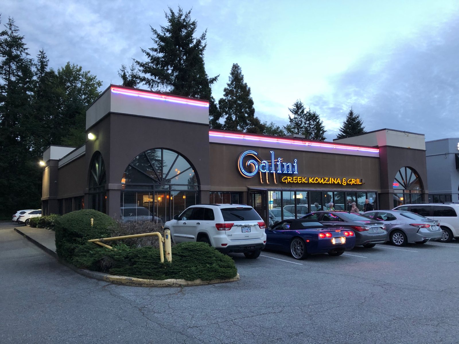 Galini Greek Kouzina & Grill's storefront at dusk, its name lit up over the windows and a parking lot out front