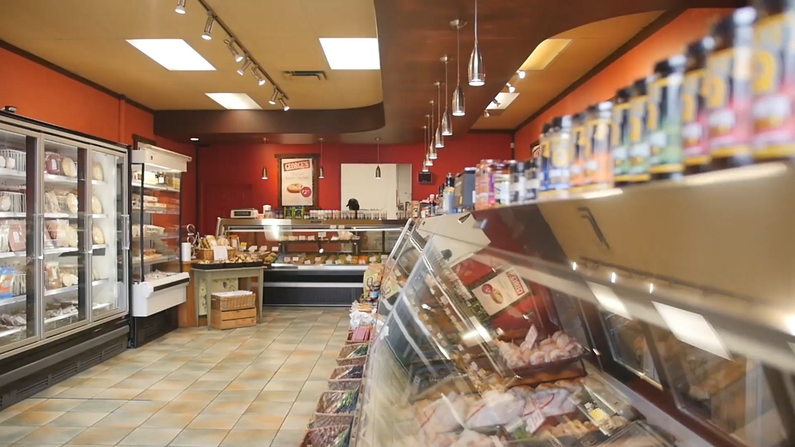 Inside George's: a long meat counter on the right and freezers of prepared pies and meals on the left