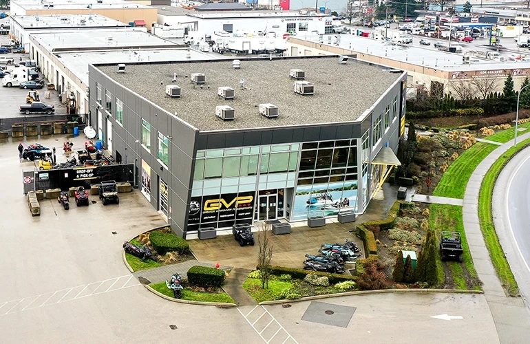 Aerial view of the Greater Vancouver Powersports building on 200 Street, with machines lined up outside the entrance