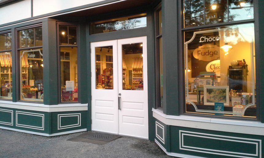 Into Chocolate's storefront in Fort Langley's Coulter Berry Building: dark green trim, white double doors and big windows full of candy