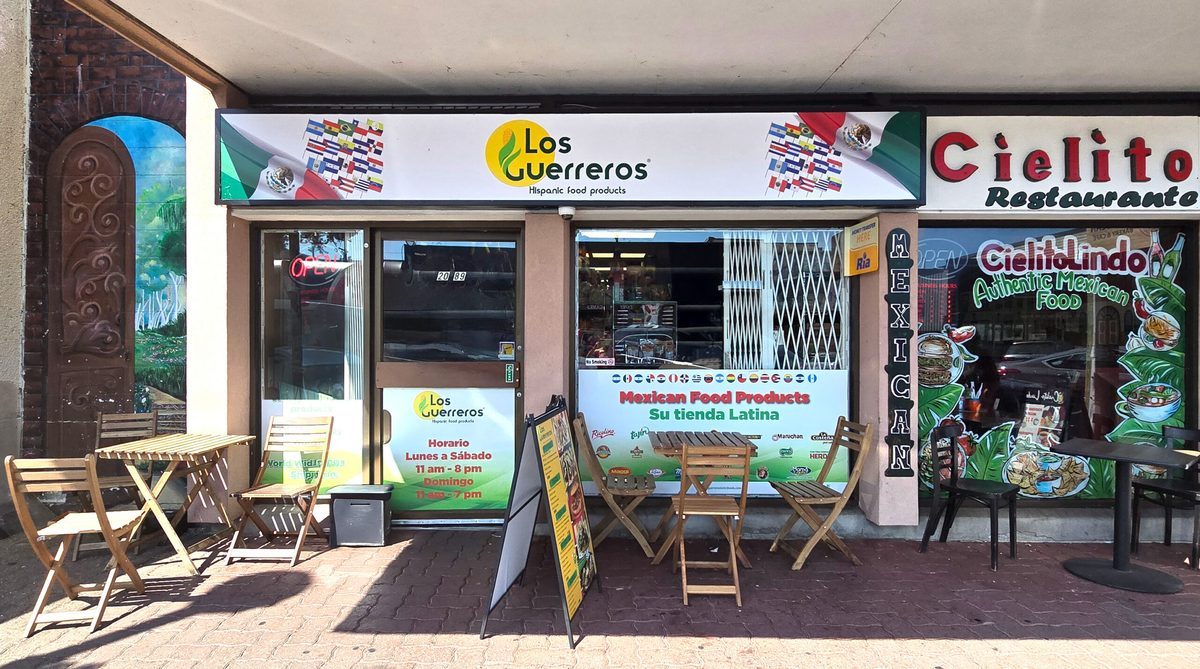 Los Guerreros Latin Foods' storefront on Fraser Highway in downtown Langley, with patio tables out front and posters in the window