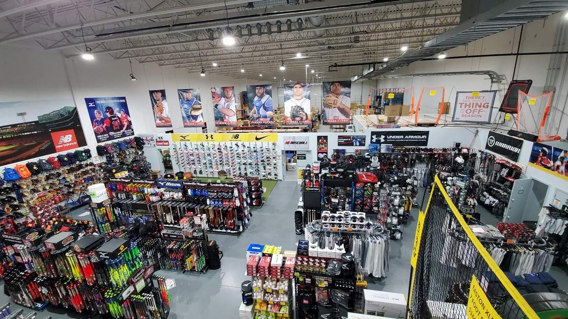 Looking down over the MVP Athletic Supplies sales floor: racks of bats, cleats, team gear and banners of ball players on the walls