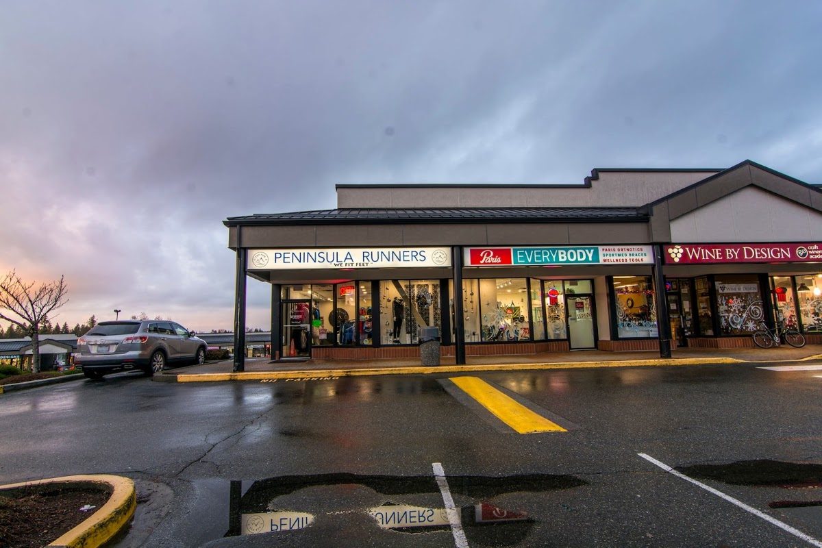 The Peninsula Runners storefront in a Walnut Grove strip mall on 88 Avenue, under a cloudy evening sky with the parking lot in front