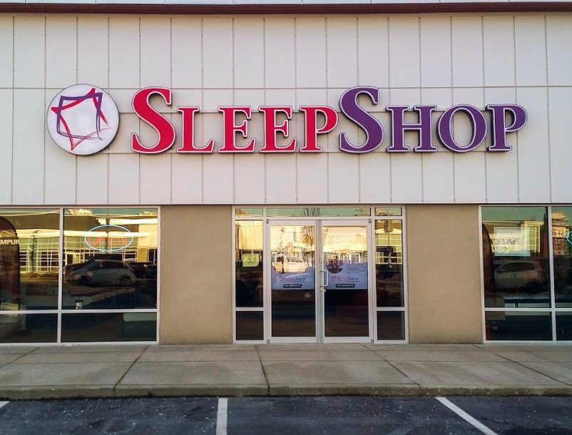 The Sleep Shop storefront on the Langley Bypass, a big red and purple sign over glass doors