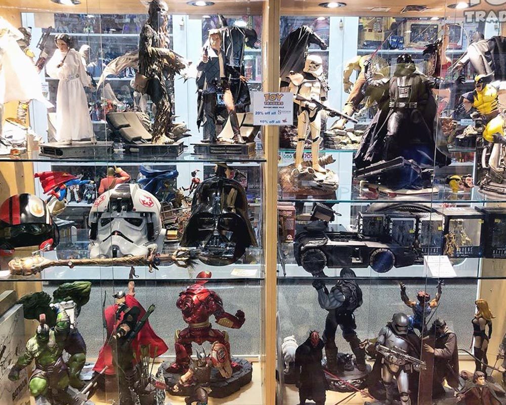 Glass display cases at Toy Traders full of Star Wars figures and statues, including stormtroopers and Darth Vader