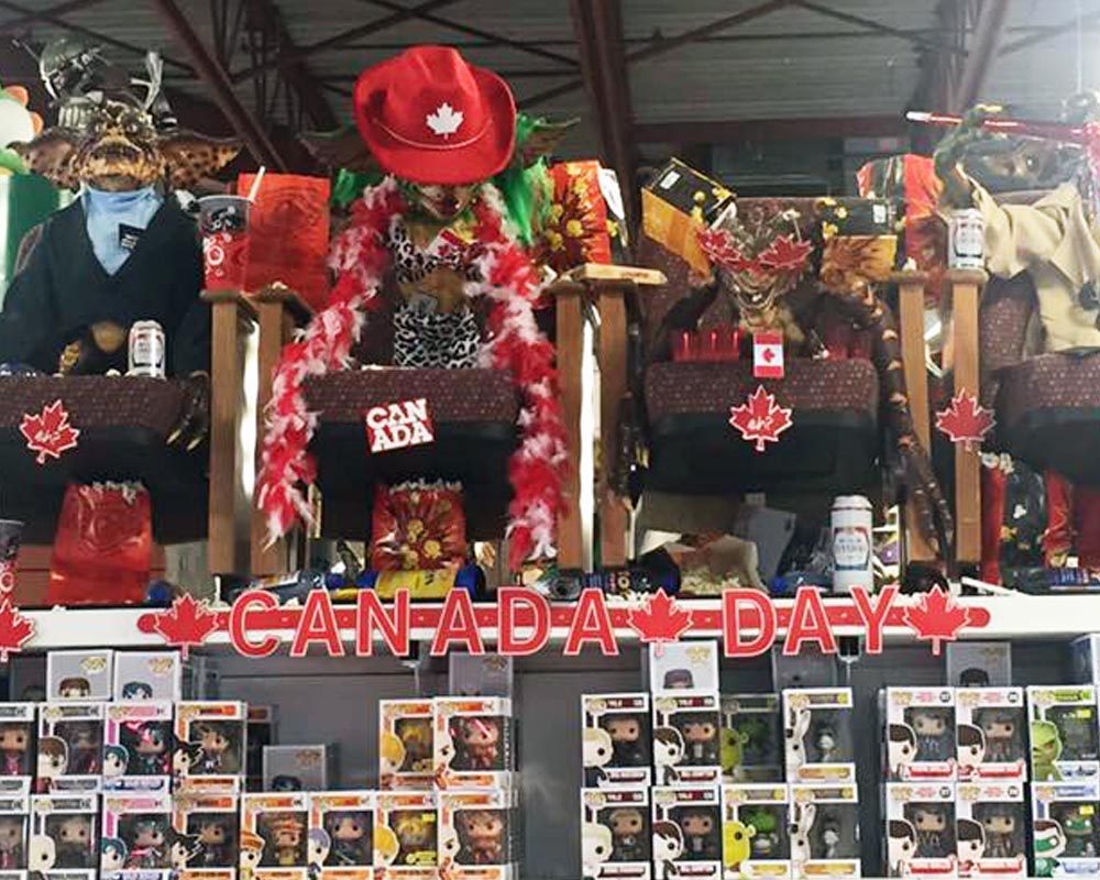 A Gremlins display at Toy Traders decked out in red and white for Canada Day, above shelves of boxed figures
