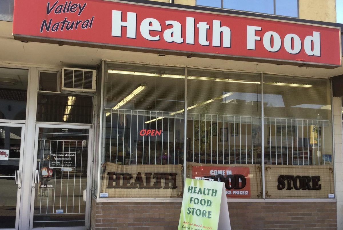 Valley Natural Health's storefront on Douglas Crescent with a red Health Food sign over the window and a sandwich board out front