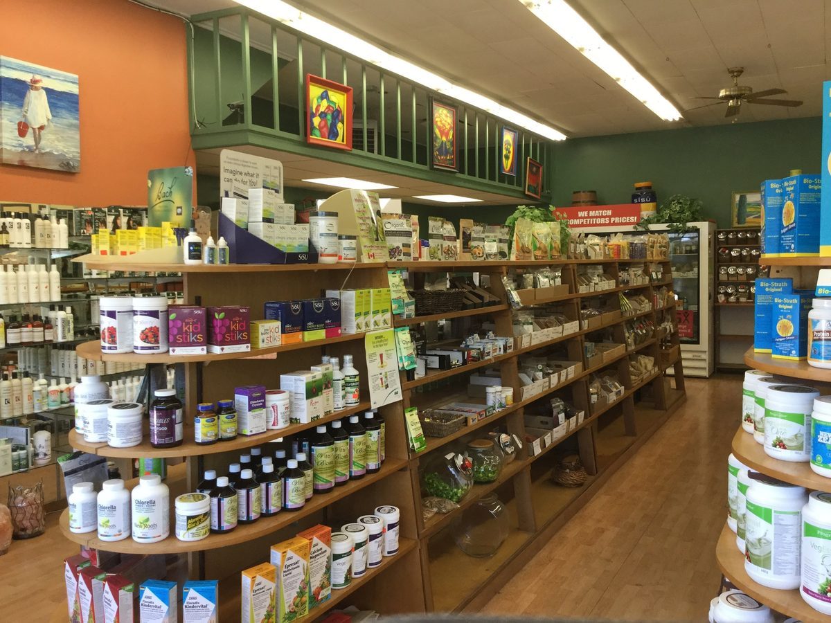 Wooden shelves of vitamins, supplements and pantry goods inside Valley Natural Health