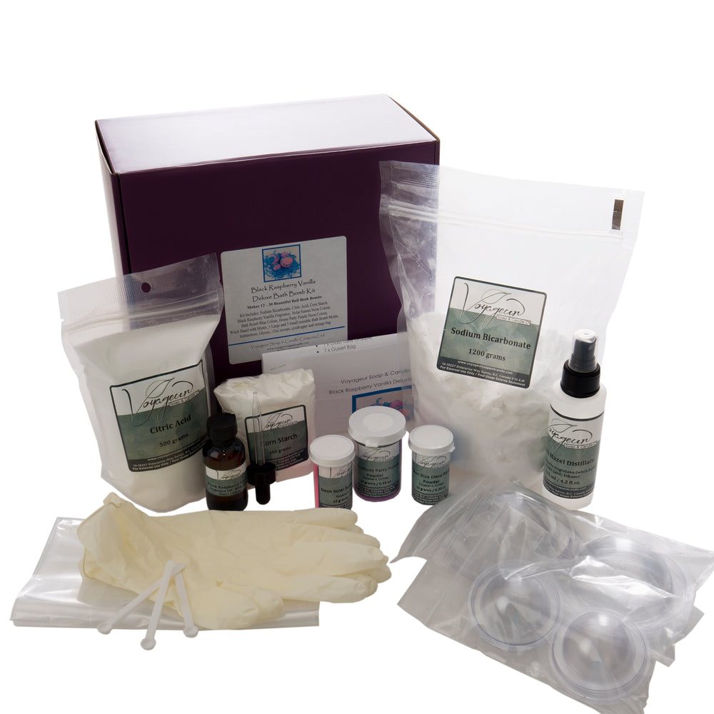 A Black Raspberry Vanilla bath bomb kit: a purple box with Voyageur bags of citric acid and baking soda, colour jars, gloves and clear moulds