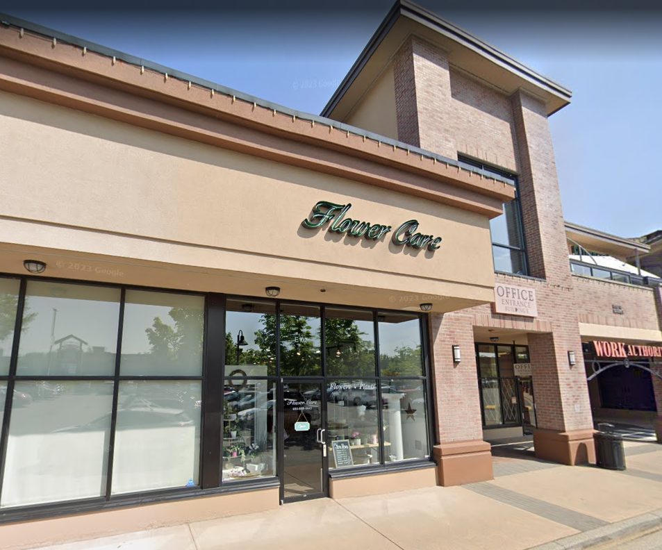 The boutique's glass storefront at Thunderbird Centre, under the older 'Flower Care' sign