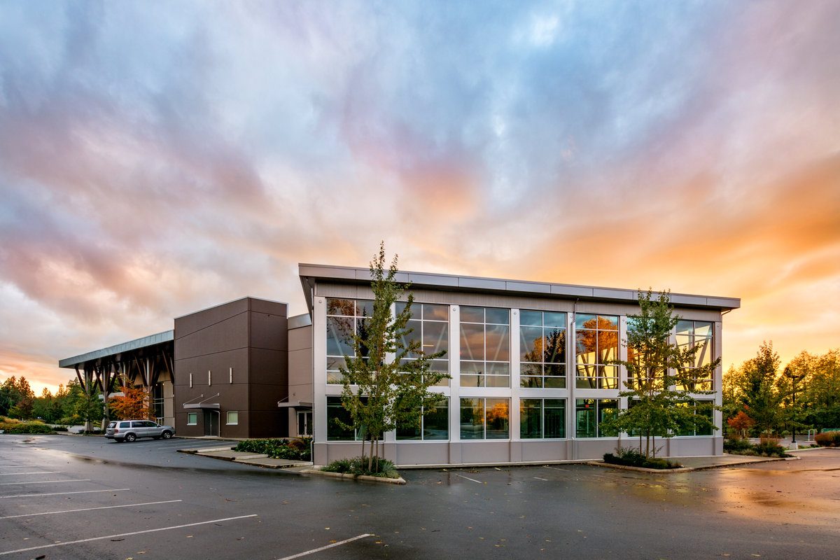 The modern two-storey Church in the Valley building on Old Yale Road at sunset, with a glass front and parking lot