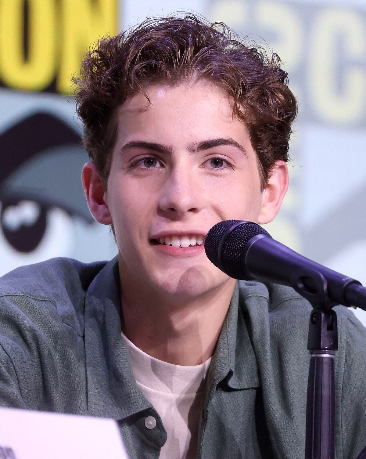 Jacob Tremblay speaking into a microphone at San Diego Comic-Con in 2025