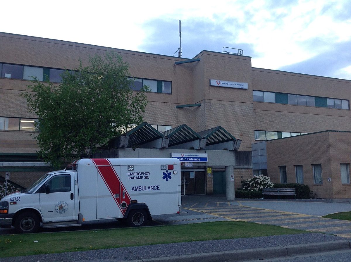 The main entrance of Langley Memorial Hospital, with an ambulance parked out front
