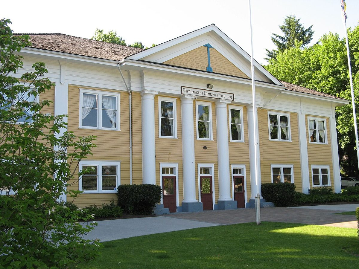 The white wooden Fort Langley Community Hall on Glover Road, with its columned porch and lawn