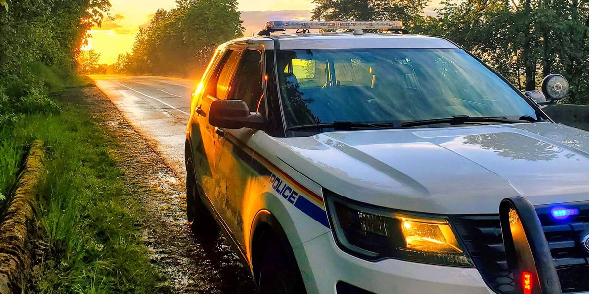 A Langley RCMP police SUV parked on a country road at sunset