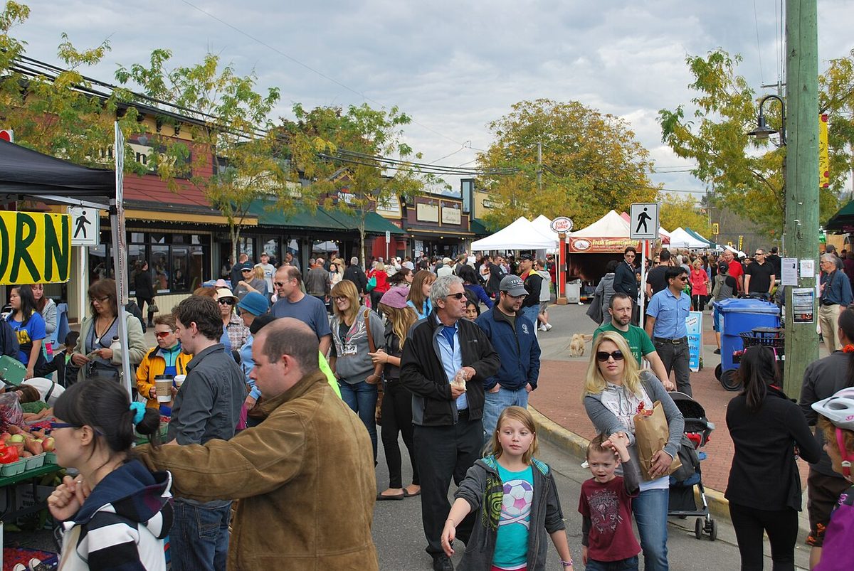 Crowds walking among vendor tents along Glover Road during the Fort Langley Cranberry Festival