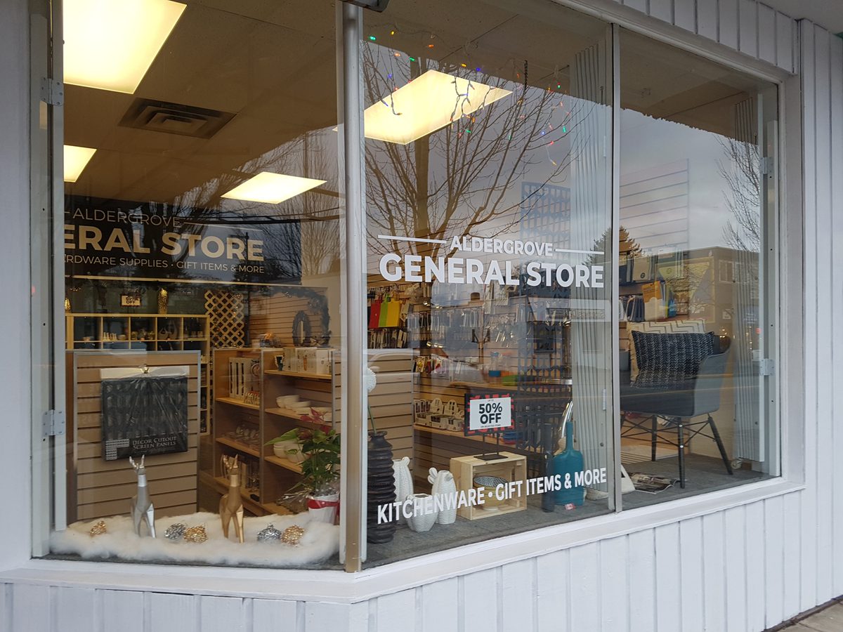 The Aldergrove General Store storefront on Fraser Highway, with kitchenware and gift displays visible through the window