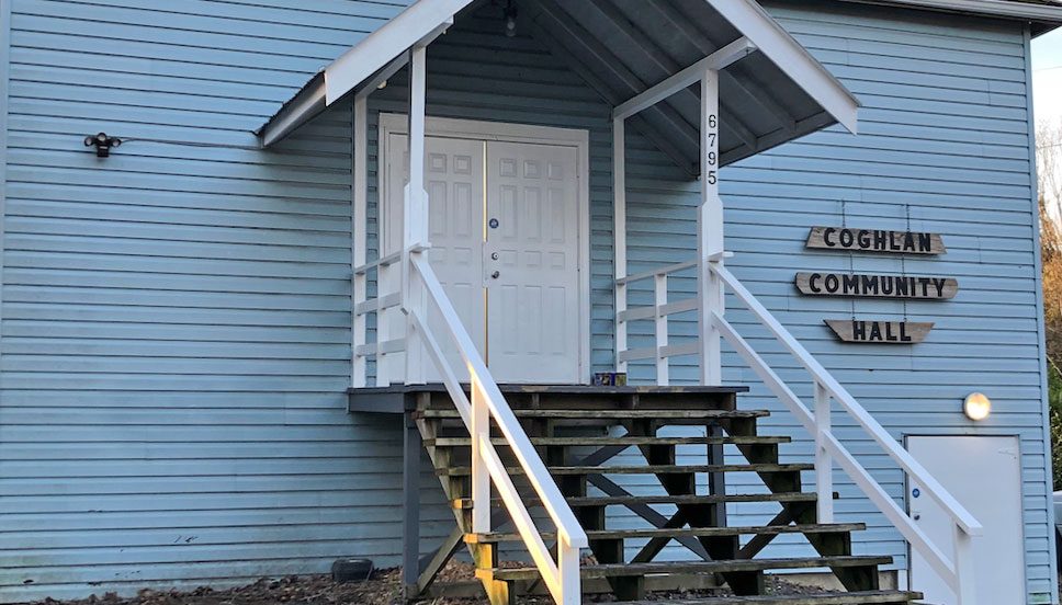 The front steps and pale blue wooden wall of Coghlan Community Hall at 6795 256 Street in Langley
