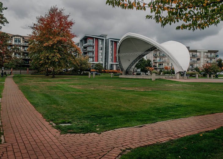 Spirit Square in Douglas Park with its white bandshell and new apartment buildings behind, Langley City