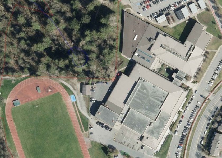 Aerial view of the Walnut Grove Secondary buildings with the school running track at left, beside Walnut Grove Community Park