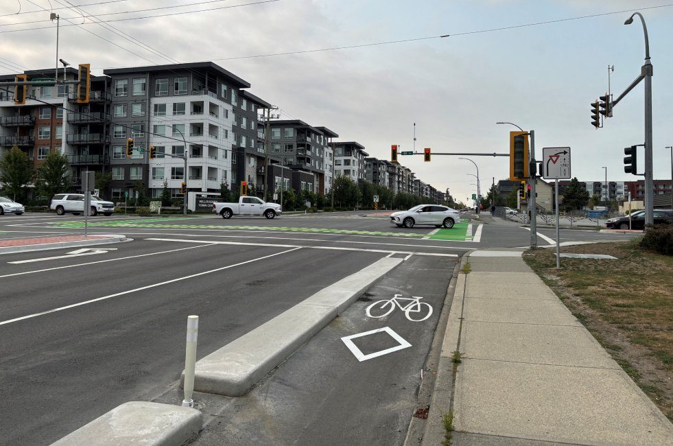 208 Street at 80 Avenue in Yorkson, with a protected bike lane, new crossing markings and apartment buildings along the widened road