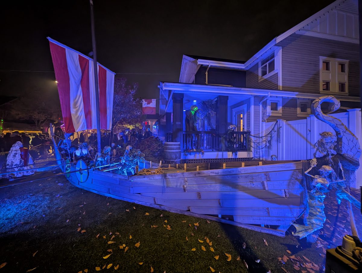 The Viking longship, sail up, skeleton crew aboard