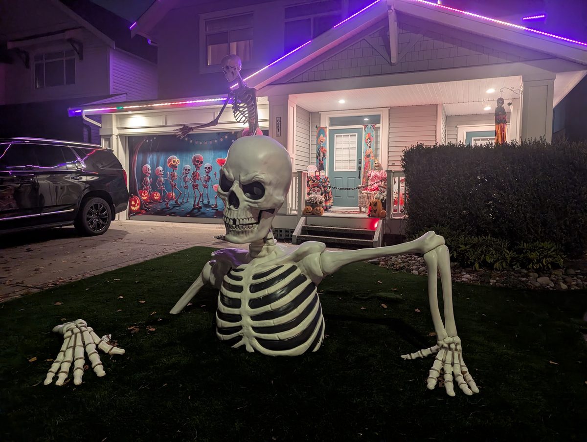 A skeleton climbing out of the lawn