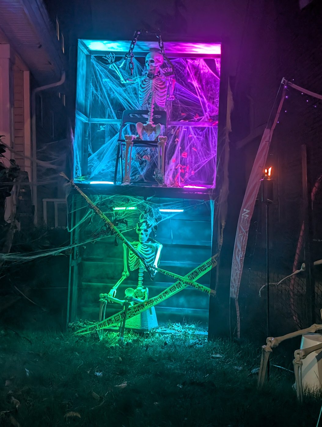 Lit cages in the windows, full of bones
