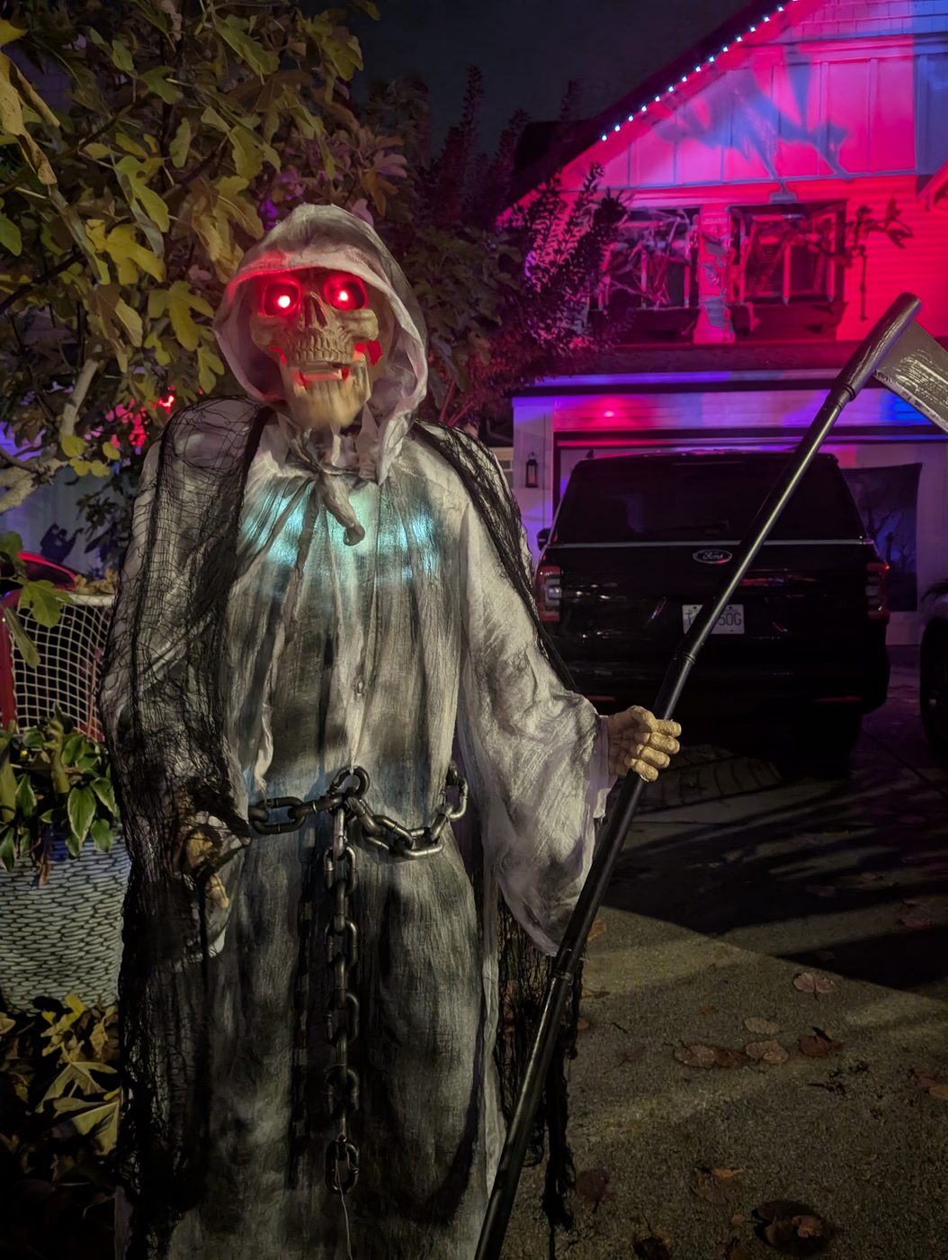 A grim reaper with glowing red eyes